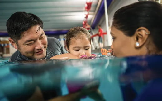 a man and a woman looking at a child