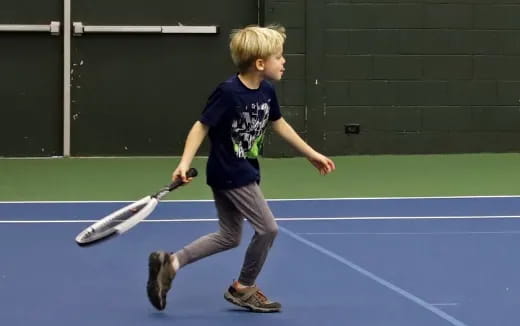 a boy playing tennis