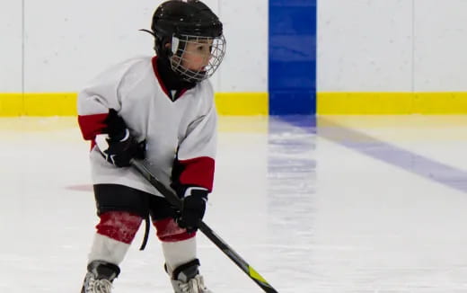 a young boy playing hockey