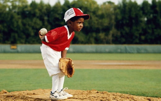 a kid pitching a baseball