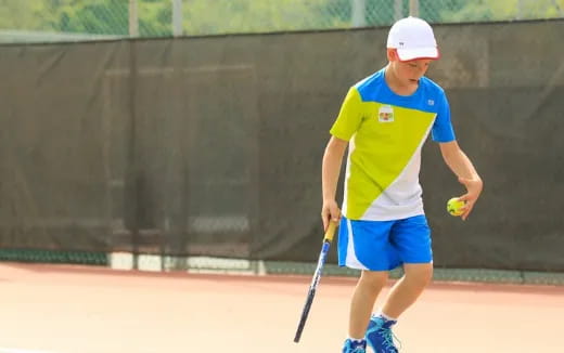 a boy playing tennis