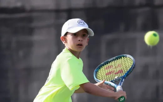 a boy playing tennis