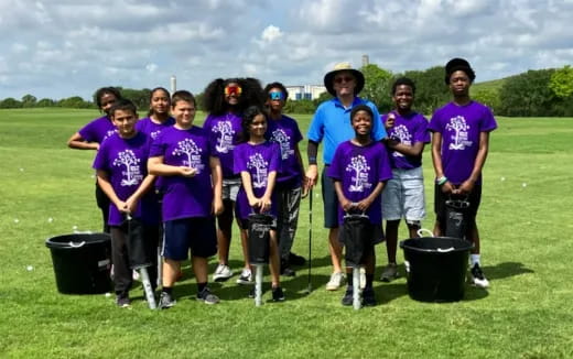 a group of people wearing purple shirts