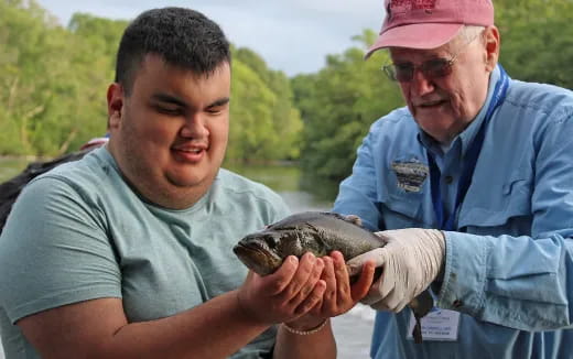 a man holding a fish