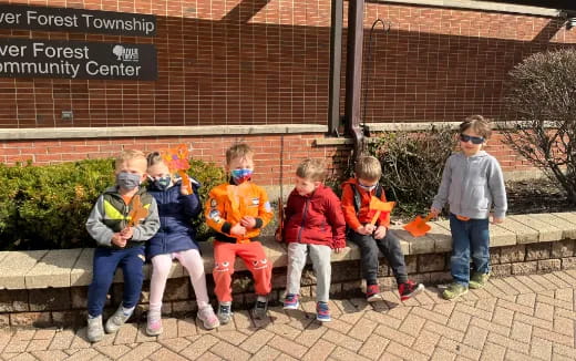 a group of kids sitting on a bench