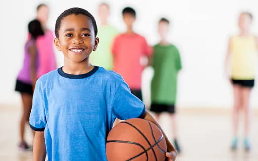 a boy holding a basketball