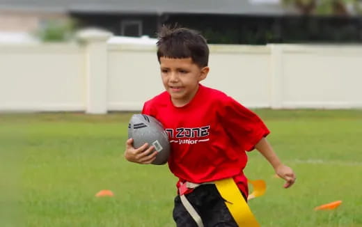 a boy holding a ball