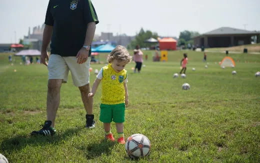 a person and a child playing football
