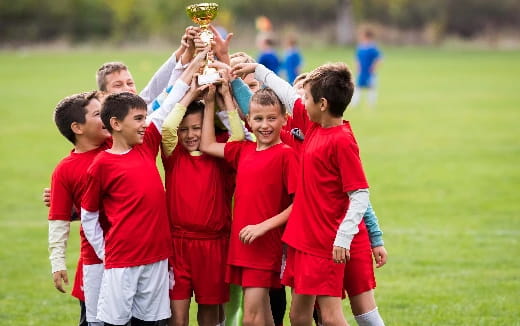 a group of boys in red uniforms