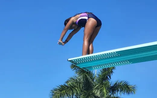 a woman climbing a trampoline