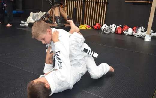 a couple of boys in karate uniforms