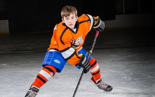 a boy wearing hockey gear