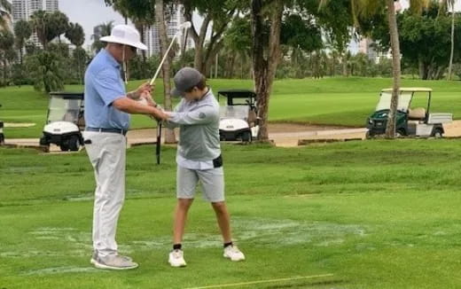 a man and a boy playing golf