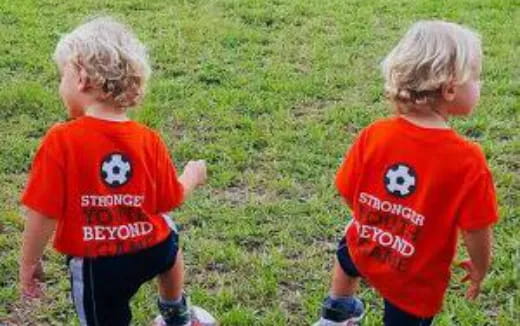 two children in red shirts