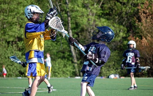 a group of people playing lacrosse