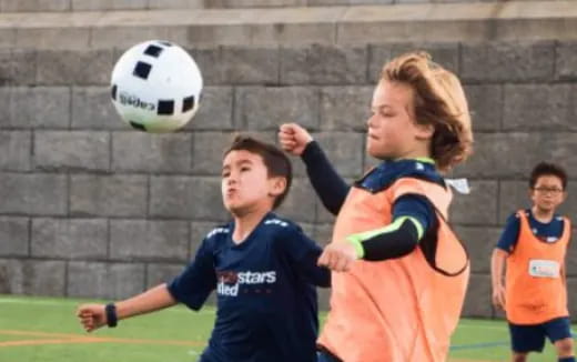 a group of kids playing football