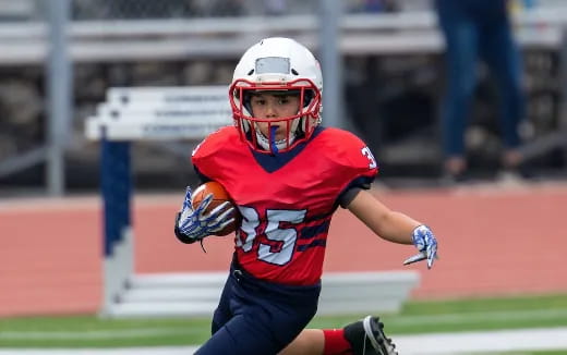 a football player running with a football