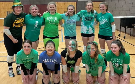 a group of girls in green shirts
