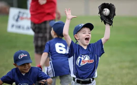 a group of kids playing baseball