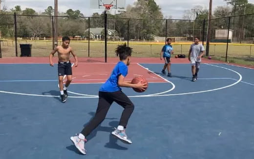 a group of people playing basketball