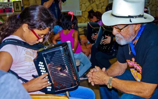a man showing a woman something on a tablet