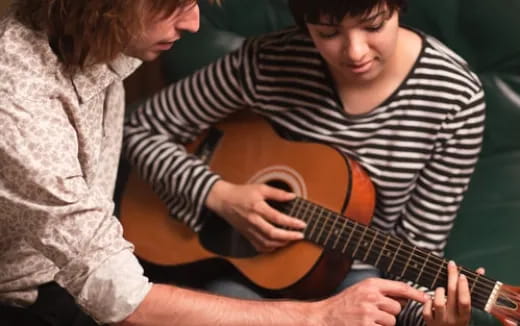 a person playing a guitar