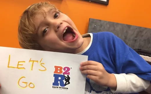 a child holding a sign