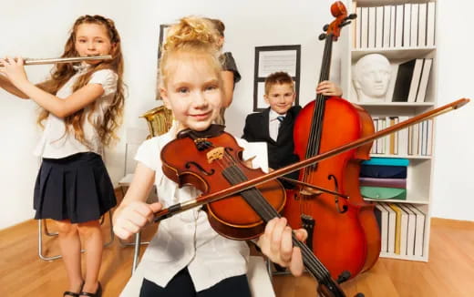 a group of kids playing violin