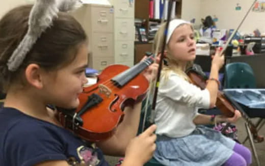 a girl playing a violin