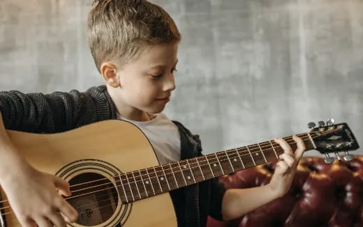 a boy playing a guitar