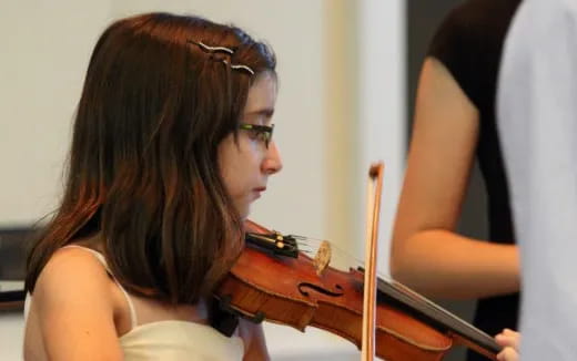 a woman playing a violin