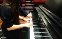 a woman playing a piano