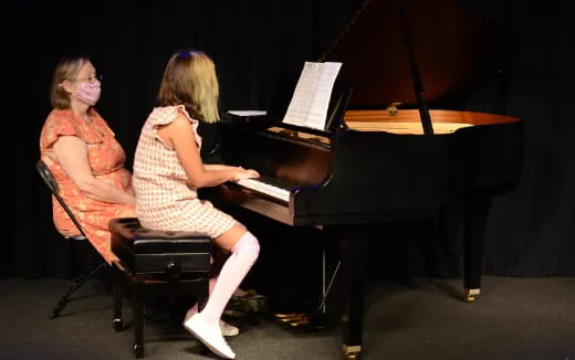 a woman playing a piano