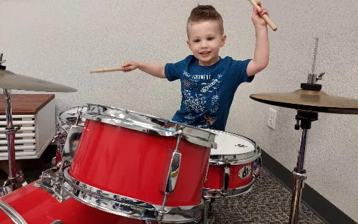 a boy playing drums