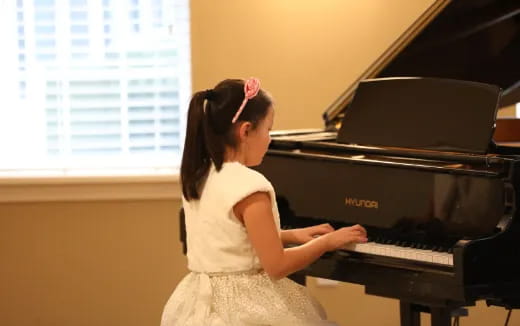 a girl playing a piano