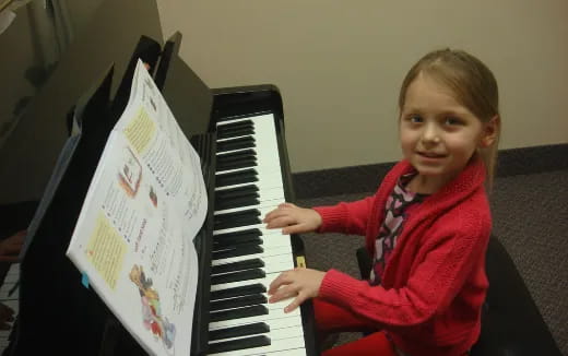 a girl playing a piano