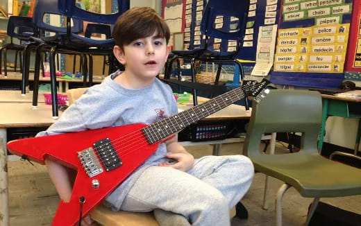 a boy playing a guitar