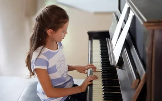 a girl playing a piano