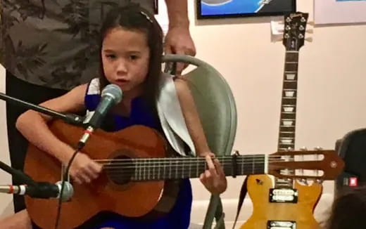 a girl playing a guitar