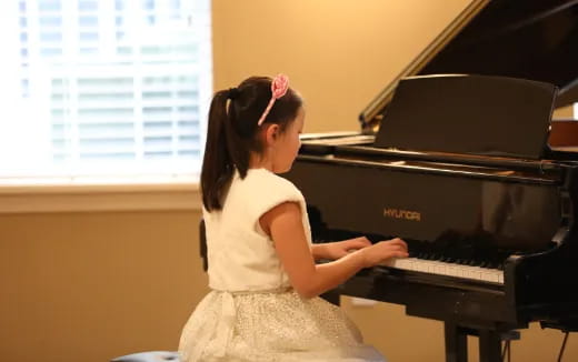 a girl playing a piano