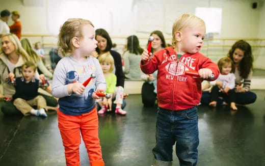 a couple of children playing with a toy