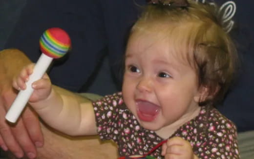 a baby brushing her teeth