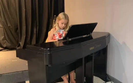 a girl playing a piano