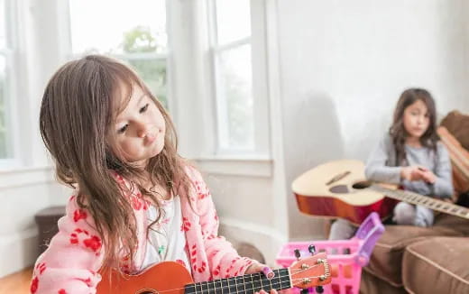 a girl playing a guitar