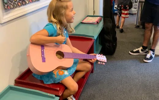 a girl sitting on a bench