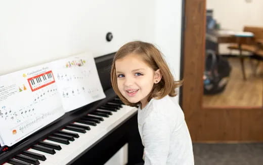 a girl playing a piano