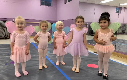 a group of girls in dresses