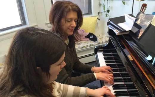 a woman playing a piano
