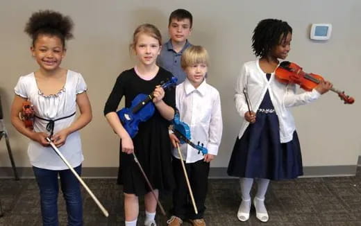 a group of kids playing instruments