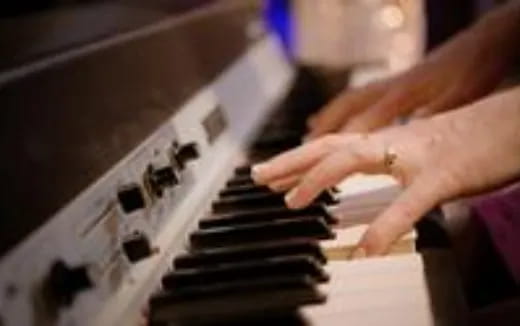 hands playing a piano